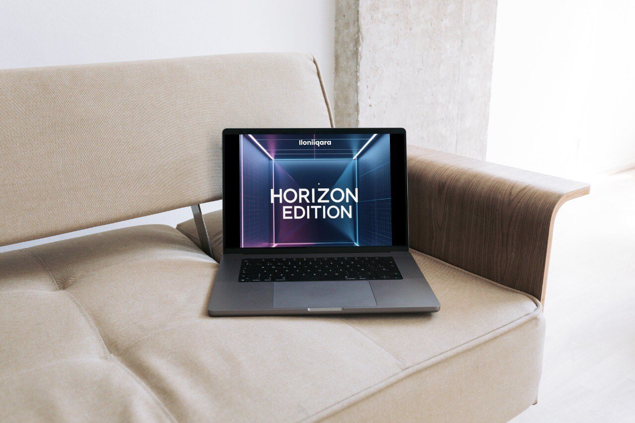 Laptop on a beige couch with 'Horizon Edition' guide displayed on the screen