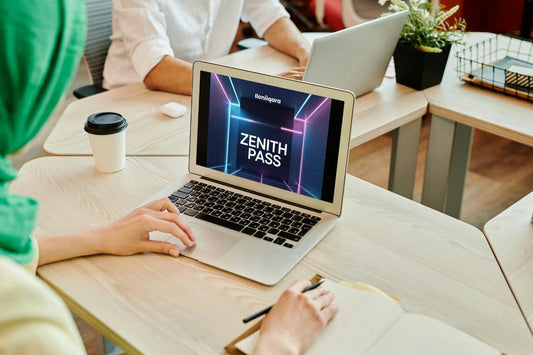Person using a laptop with 'Zenith Pass' displayed on the screen in an office setting.